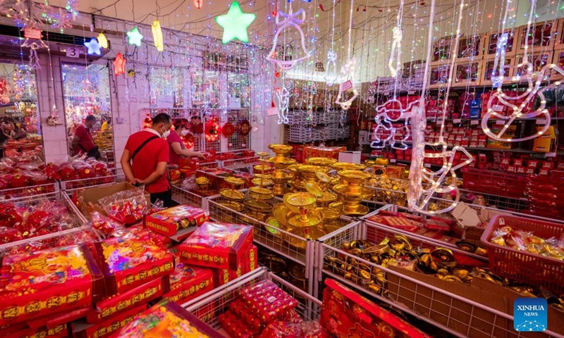 People buy decorations for Chinese New Year at a store in Kuala Lumpur, Malaysia, Jan. 23, 2022.Photo:Xinhua