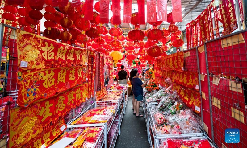 People buy decorations for Chinese New Year at a store in Kuala Lumpur, Malaysia, Jan. 23, 2022.Photo:Xinhua