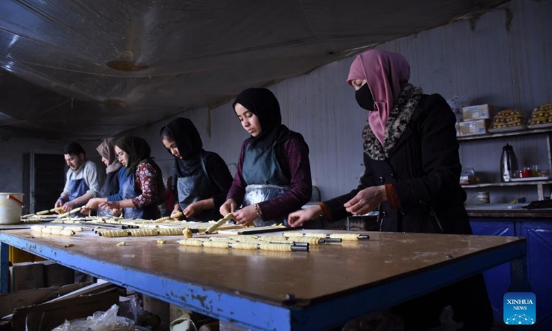 People work at a confectionery factory in Mazar-i-Sharif, capital of Balkh province, Afghanistan, Jan. 18, 2022. Contrary to alleged reports of women being confined to home under Afghanistan's Taliban administration, nearly a dozen women and girls are seen hard at work in a confectionery shop here. TO TO WITH Feature: Afghan woman make their own sweet living in Mazar-i-Sharif(Photo: Xinhua)