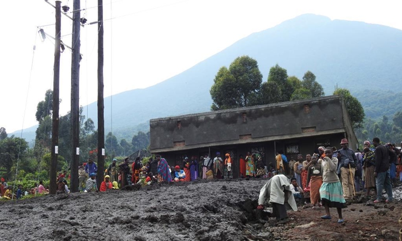 People gather near mudslides caused by heavy floods at Muramba village in Kisoro district, southwestern Uganda, on Jan. 25, 2022. The death toll from heavy flooding following torrential rains in Kisoro has risen to nine, a humanitarian relief agency said Tuesday.(Photo: Xinhua)