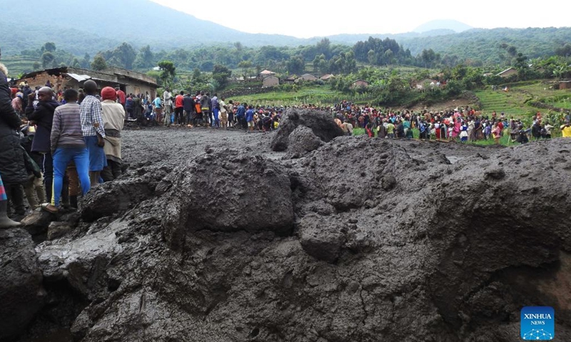 People gather near mudslides caused by heavy floods at Muramba trading center in Kisoro district, southwestern Uganda, on Jan. 25, 2022. The death toll from heavy flooding following torrential rains in Kisoro has risen to nine, a humanitarian relief agency said Tuesday.(Photo: Xinhua)