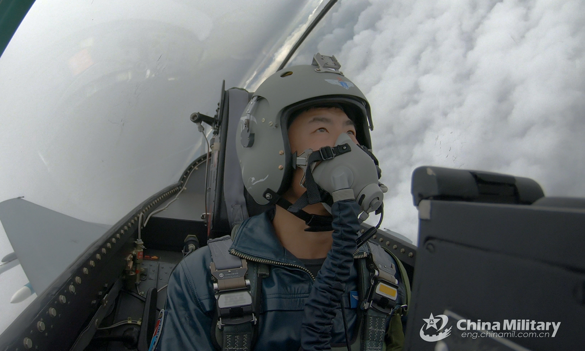 A pilot assigned to an aviation brigade of the air force under the PLA Southern Theater Command flies his fighter jet above the clouds during an air combat flight training exercise on January 17, 2022. (eng.chinamil.com.cn/Photo by Wu Gaoming) 