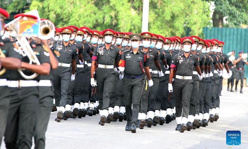 Military personnel wearing face masks take part in a rehearsal for the Independence Day parade in Colombo, Sri Lanka, on Jan. 31, 2022. Sri Lanka will celebrate its Independence Day on Feb. 4. (Photo by Ajith Perera/Xinhua)