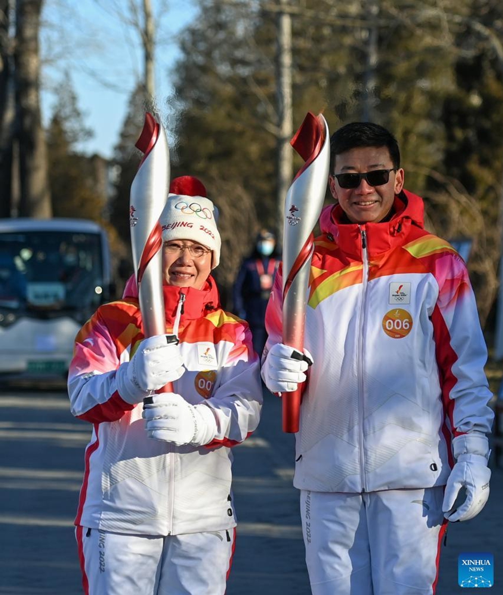 Torch bearers Zhu Dongyun (L) and Chen Zhongwei attend the Beijing 2022 Olympic Torch Relay at the Summer Palace in Beijing, capital of China, Feb. 4, 2022. (Xinhua/Chen Yehua)