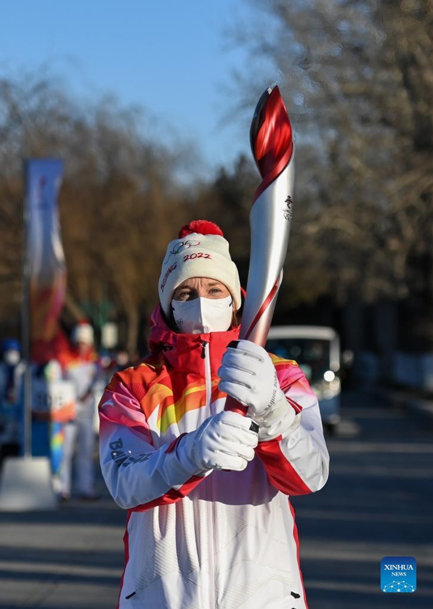 Torch bearer Rebecca Wardell runs with the torch during the Beijing 2022 Olympic Torch Relay at the Summer Palace in Beijing, capital of China, Feb. 4, 2022. (Xinhua/Chen Yehua)