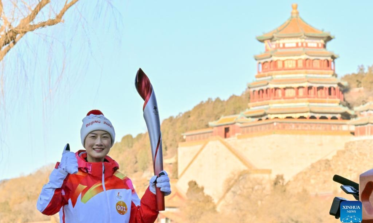 Torch bearer Ding Ning runs with the torch during the Beijing 2022 Olympic Torch Relay at the Summer Palace in Beijing, capital of China, Feb. 4, 2022. (Xinhua/Jin Liangkuai)