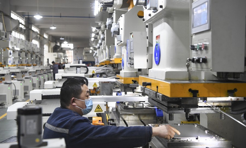 Staff members work at a manufacturing company in southwest China's Chongqing Municipality, Feb. 8, 2022.(Photo: Xinhua)