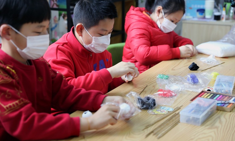 Children make Bing Dwen Dwen, the mascot for the Beijing 2022 Olympic Winter Games, with colored clay at Xidu sub-district of Fengxian District in east China's Shanghai, Feb. 10, 2022.(Photo: Xinhua)