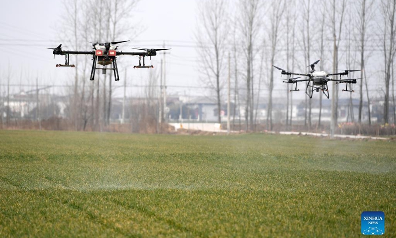 Drones are used to spray herbicide at an unmanned farm in Zhaoqiao Town of Bozhou City, east China's Anhui Province, Feb. 11, 2022. Recently, a newly-built unmanned farm in Bozhou ushered in its first spring farming production season. The farm is equipped with more than 20 plant protection drones, one unmanned harvester, and one unmanned seeder, as well as intelligent systems for irrigation, fertilization, and pest control(Photo: Xinhua)