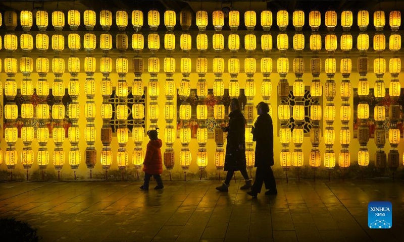 People enjoy the light installations to celebrate the upcoming Latern Festival at the Tengwang Pavilion scenic spot in Nanchang, capital of east China's Jiangxi Province, Feb. 12, 2022. The Lantern Festival, the 15th day of the first month of the Chinese lunar calendar, falls on Feb. 15 this year, which features family reunions, feasts, light shows and various cultural activities. (Xinhua/Wan Xiang)