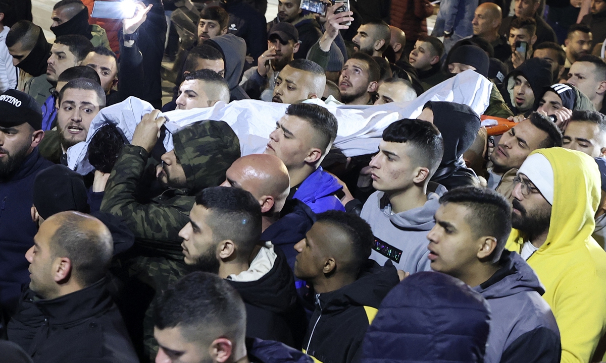 Palestinians carry the body of Mohamad Abu Saleh, 17, after he was killed during clashes with Israeli forces in the occupied West Bank village Al Yamun, near Jenin, Palestinian territories on February 14, 2022. Photo: AFP