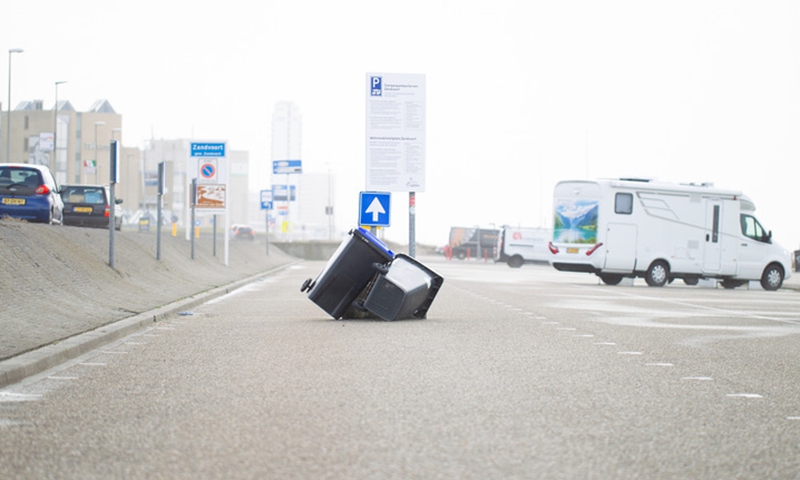 Trash cans are blown on the Zandvoort Boulevard in Zandvoort, a coastal town west of Amsterdam, the Netherlands, on Feb. 18, 2022.(Photo: Xinhua)