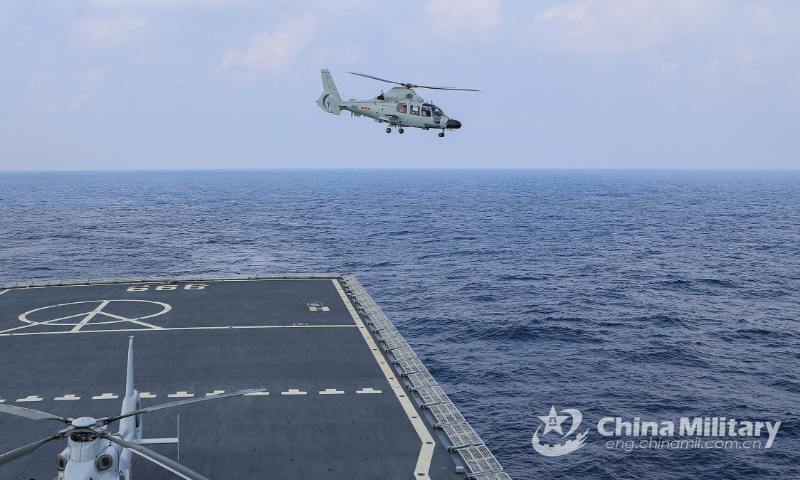 A ship-borne helicopter attached to a naval landing ship flotilla under the PLA South Theater Command takes off from the flight deck of the amphibious dock landing ship Jinggangshan (Hull 999) during the helicopter flight training on February 8, 2022. (eng.chinamil.com.cn/Photo by Qiao Chenxi)