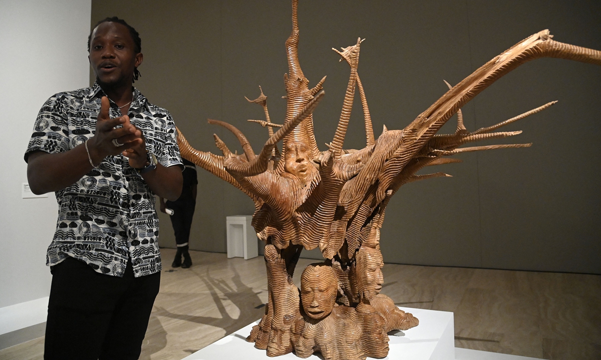 Sculptor Degnon Epaphras Toihen speaks about his work during an exhibition of returned seized Benin artifacts and exhibition of contemporary artworks at the presidency in Benin's capital Cotonou, on February 18, 2022. Photo: AFP