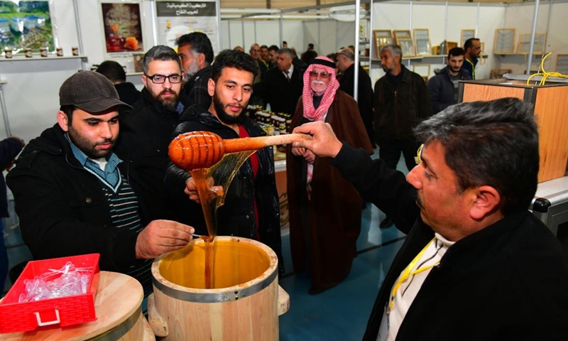 People visit the Honey Festival in Damascus, capital of Syria, Feb. 20, 2022.Photo:Xinhua