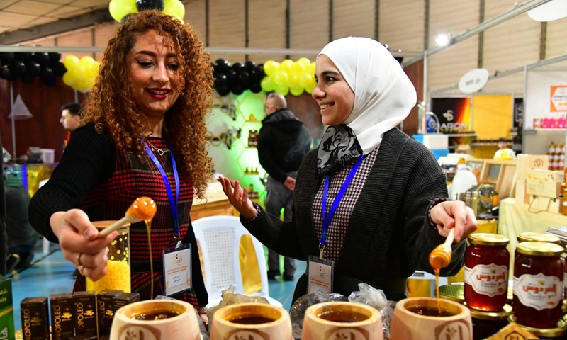 People visit the Honey Festival in Damascus, capital of Syria, Feb. 20, 2022.Photo:Xinhua