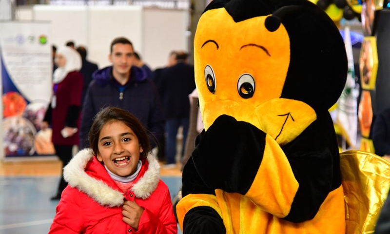 People visit the Honey Festival in Damascus, capital of Syria, Feb. 20, 2022.Photo:Xinhua