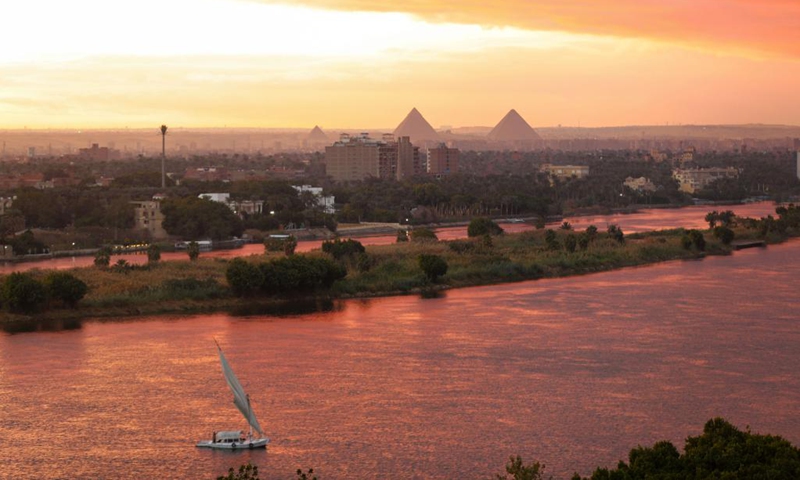 A boat sails on the Nile reddened by flaming clouds at sunset in Cairo, Egypt, on Jan. 26, 2022.(Photo: Xinhua)