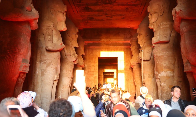 Tourists take photos of sculptures illuminated by a ray of sunlight at the Great Temple of Abu Simbel during the Sun Festival in Aswan, Egypt, Feb. 22, 2022.(Photo: Xinhua)