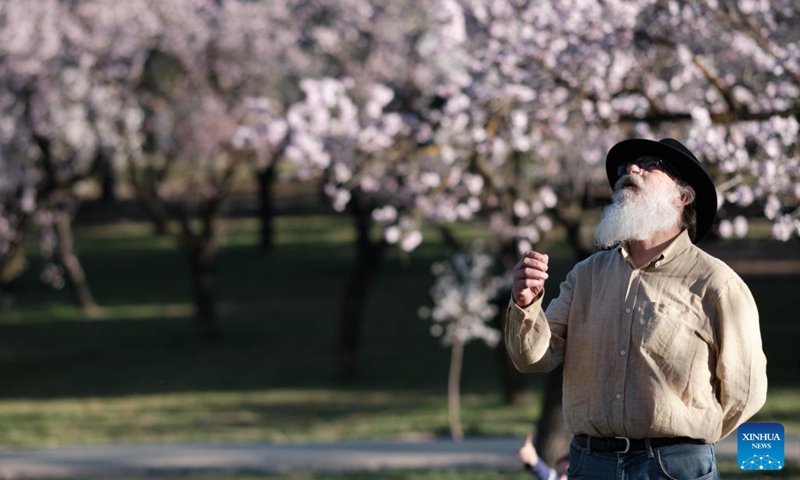 A man views flowers at a park in Madrid, Spain, Feb. 22, 2022.(Photo: Xinhua)