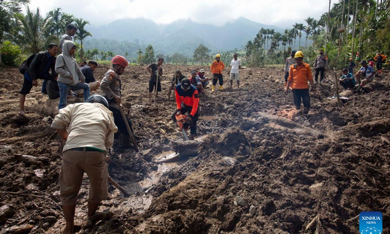 Search And Rescue (SAR) team members search in a muddy area caused by landslides after a 6.1 magnitude quake in Pasaman Barat, West Sumatra, Indonesia, Feb. 27, 2022. (Photo by Andry Mardiansyah/Xinhua)