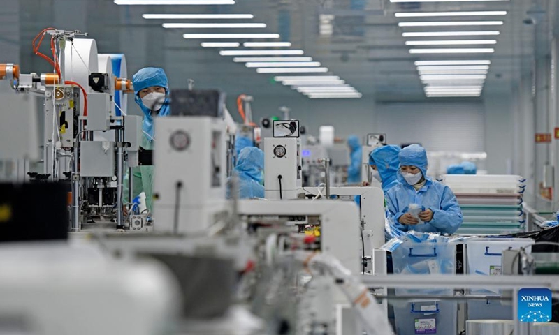 Staff members work at a workshop of Naton Medical Protective Equipment (Tianjin) Co., Ltd. in Tianjin, north China, Feb 23, 2022.Photo:Xinhua