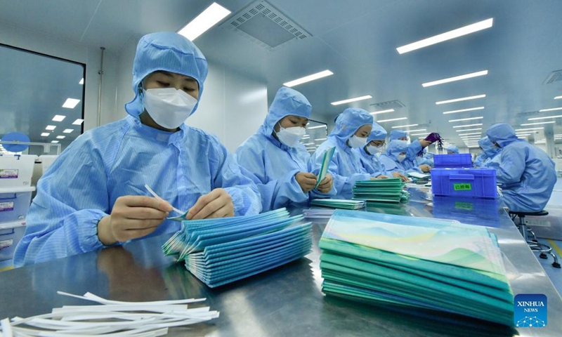 Staff members work at a workshop of Naton Medical Protective Equipment (Tianjin) Co., Ltd. in Tianjin, north China, Feb 23, 2022.Photo:Xinhua