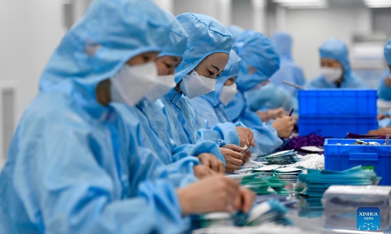 Staff members work at a workshop of Naton Medical Protective Equipment (Tianjin) Co., Ltd. in Tianjin, north China, Feb 23, 2022.Photo:Xinhua