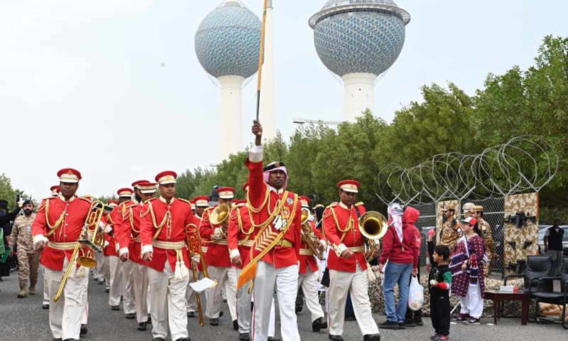 People march during celebrations of Kuwait's National and Liberation Days in Kuwait City, Kuwait, on Feb. 25, 2022. Celebrations were held on Friday to mark Kuwait's National and Liberation Days, which are observed annually on Feb. 25 and Feb. 26.(Photo: Xinhua)