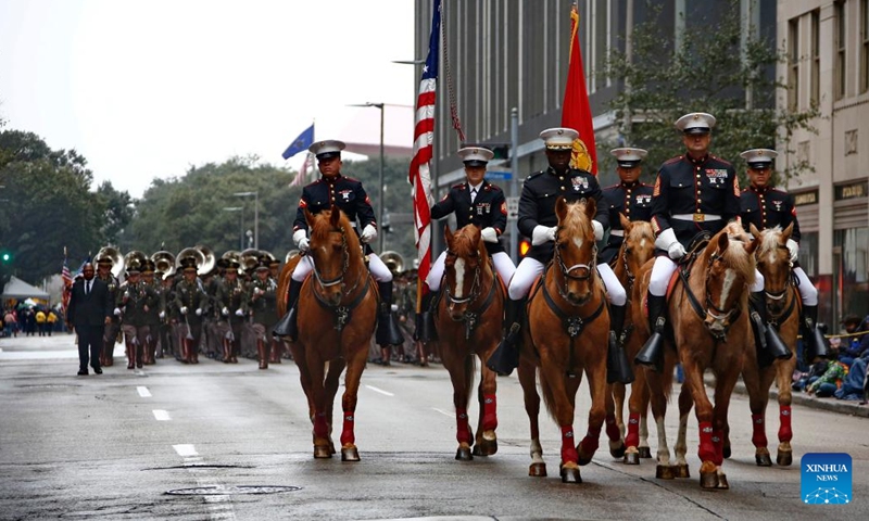 Flag guards march during the 90th Downtown Rodeo Parade in Houston, Texas, the United States, Feb. 26, 2022. (Photo by Lao Chengyue/Xinhua)