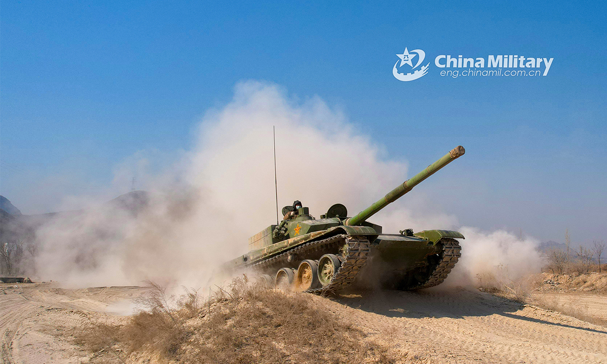 A main battle tank attached to a brigade under the PLA 82nd Group Army rumbles on a slope during a driving skills training exercise on February 24, 2022. (eng.chinamil.com.cn/Photo by Sun Tongkai)