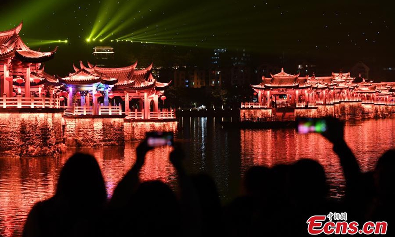 Guangji Bridge is illuminated during a light show in Chaozhou, south China's Guangdong Province, Feb. 28, 2022. Guangji Bridge is located on the Hanjiang River in the east of the ancient city of Chaozhou. The pontoon bridge is connected by wooden boats, which are connected in the morning and disconnected in the evening to facilitate the navigation of passing ships. (Photo: China News Service/Chen Chuhong)