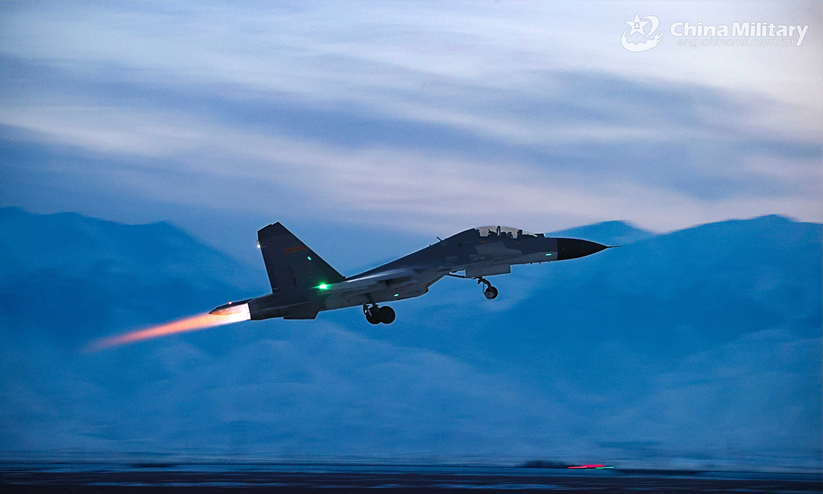 A fighter jet attached to an aviation brigade under the PLA Air Force takes off from the runway during a round-the-clock training exercise on February 20, 2022. (eng.chinamil.com.cn/Photo by Cui Baoliang)