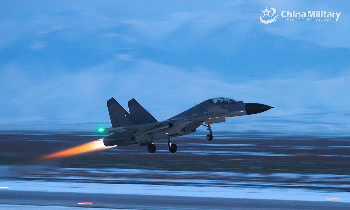 A fighter jet attached to an aviation brigade under the PLA Air Force takes off from the runway during a round-the-clock training exercise on February 20, 2022. (eng.chinamil.com.cn/Photo by Cui Baoliang)