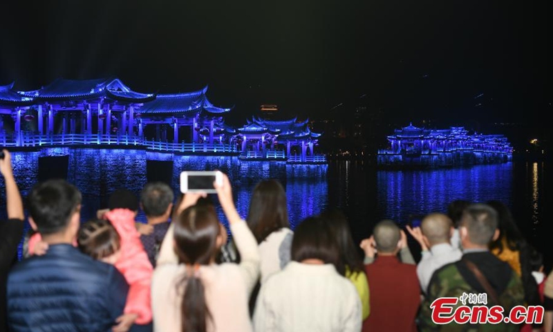 Guangji Bridge is illuminated during a light show in Chaozhou, south China's Guangdong Province, Feb. 28, 2022. Guangji Bridge is located on the Hanjiang River in the east of the ancient city of Chaozhou. The pontoon bridge is connected by wooden boats, which are connected in the morning and disconnected in the evening to facilitate the navigation of passing ships. (Photo: China News Service/Chen Chuhong)