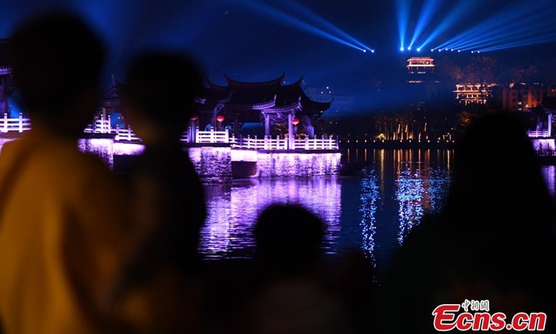 Guangji Bridge is illuminated during a light show in Chaozhou, south China's Guangdong Province, Feb. 28, 2022. Guangji Bridge is located on the Hanjiang River in the east of the ancient city of Chaozhou. The pontoon bridge is connected by wooden boats, which are connected in the morning and disconnected in the evening to facilitate the navigation of passing ships. (Photo: China News Service/Chen Chuhong)