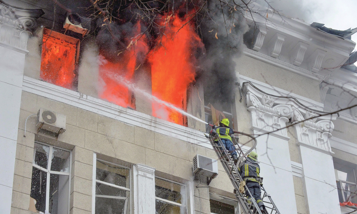 Firefighters work to contain a fire after a rocket attack in the complex of buildings housing the Kharkiv regional SBU security service and the regional police, in Kharkiv, Ukraine on March 2. Photo: VCG