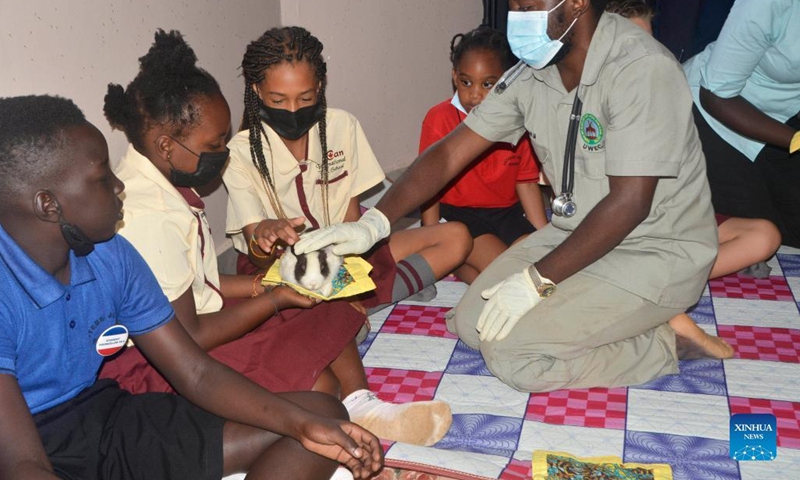 A veterinary health specialist shows ways of handling a rabbit during the World Wildlife Day celebrations at Uganda Wildlife Conservation Education Center in Entebbe, Uganda, on March 3, 2022.(Photo: Xinhua)