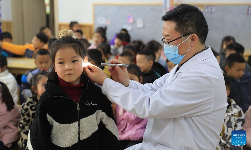 A medical worker examines a child's ears in Yuqing County, Zunyi City, southwest China's Guizhou Province, March 2, 2022. March 3 marks China's national Ear Care Day. Various activities were held to promote public awareness of hearing protection.(Photo: Xinhua)