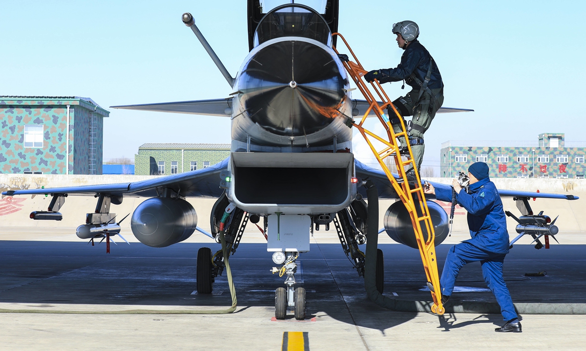 A pilot assigned to an aviation brigade of the air force under the PLA Central Theater Command climbs into the cockpit of his J-10 fighter jet prior to a round-the-clock combat flight training exercise on February 23, 2022.Photo:China Military