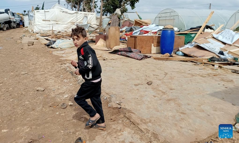 A child runs inside a camp for displaced Syrians in Akkar, northern Lebanon, on March 4, 2022. A storm destroyed many tents in the camp.Photo:Xinhua