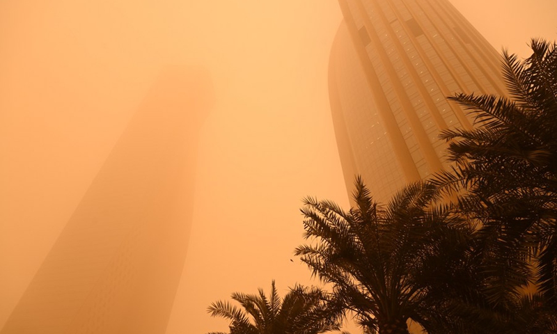 Photo taken on March 4, 2022 shows buildings shrouded in heavy dust in Kuwait City, Kuwait. A sandstorm hit Kuwait on Friday.(Photo: Xinhua)