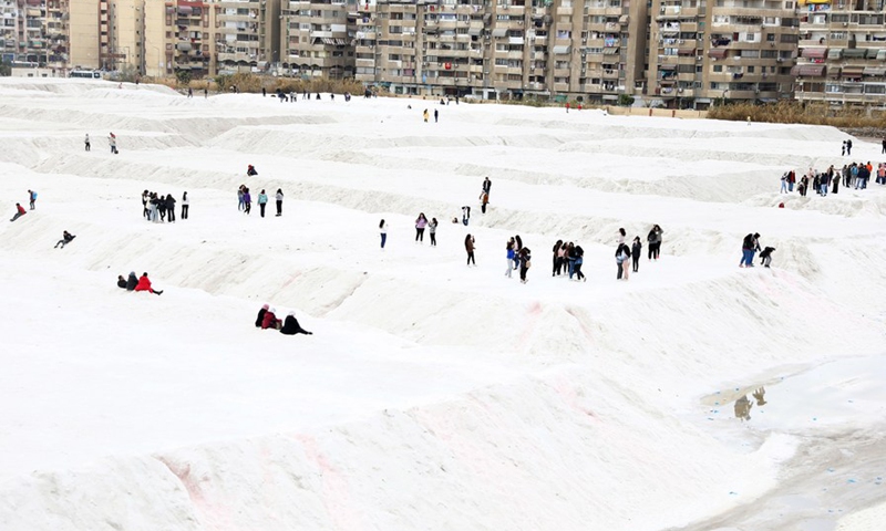 People play on the salt mountains in Port Fouad, a city in Egypt's Port Said Governorate, on March 4, 2022.(Photo: Xinhua)