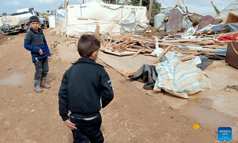 Children stand in front of collapsed tents inside a camp for displaced Syrians in Akkar, northern Lebanon, on March 4, 2022. A storm destroyed many tents in the camp.Photo:Xinhua