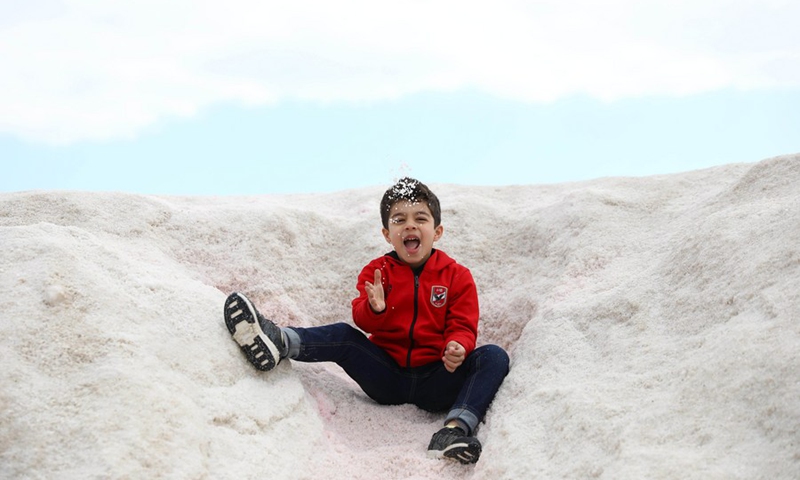 A boy plays on the salt mountains in Port Fouad, a city in Egypt's Port Said Governorate, on March 4, 2022.(Photo: Xinhua)