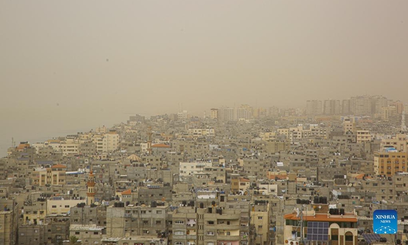 Photo taken on March 6, 2022 shows a view of Gaza City in a dust storm. (Photo by Rizek Abdeljawad/Xinhua)