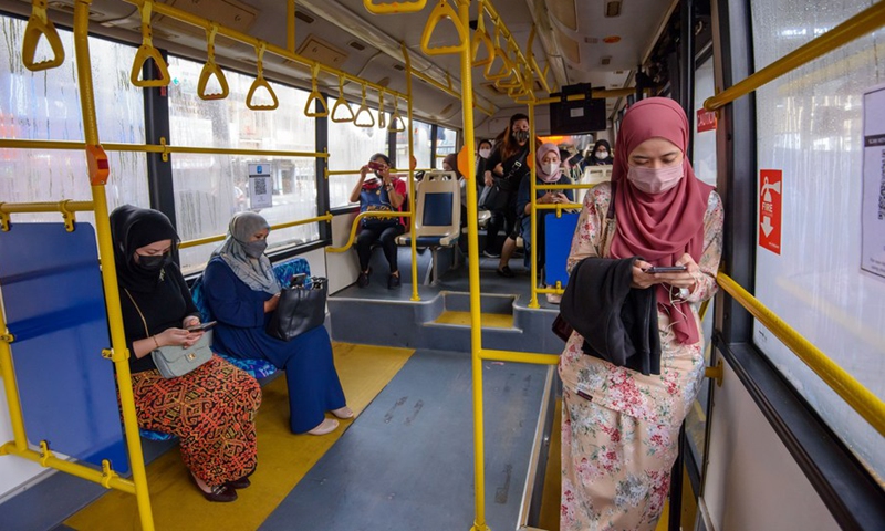 Women wearing face masks take a ladies' coach at a bus station in Kuala Lumpur, Malaysia, March 7, 2022.(Photo: Xinhua)