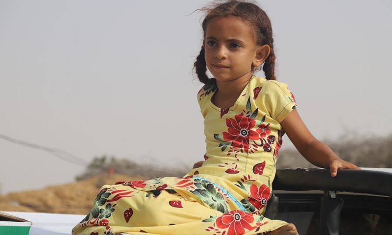 A Yemeni girl sits on a truck outside a charity center in Midi District, Hajjah province, northern Yemen on March 7. 2022.(Photo: Xinhua)