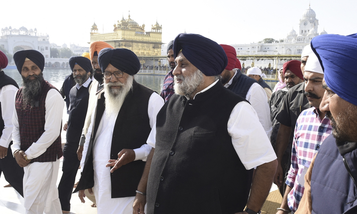 Shiromani Akali Dal (SAD) party president Sukhbir Singh Badal (second right) visits the Golden Temple to pay his respects a day before the state assembly election results in Amritsar, India on March 9, 2022. Photo: AFP