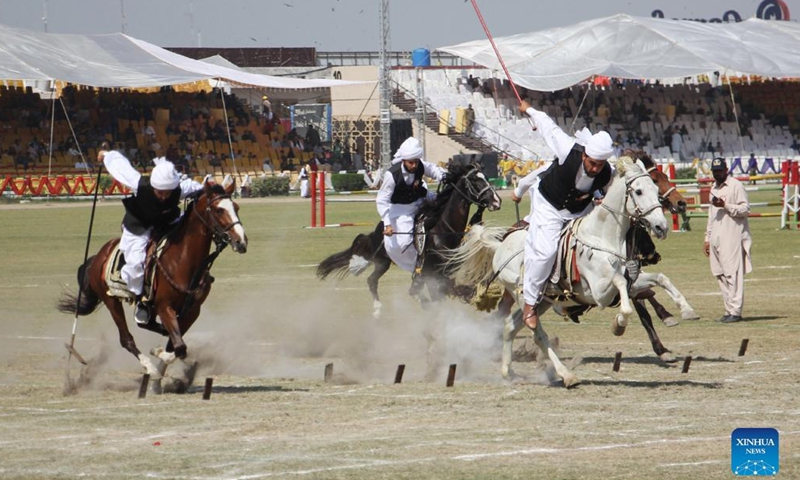 Pakistanis perform during a horse and cattle show in Lahore, Pakistan on March 11, 2022.Photo:Xinhua